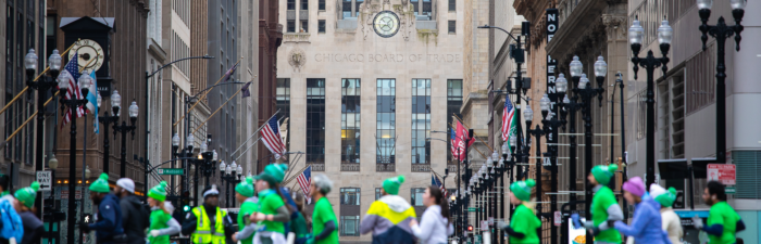 Participants passing the Chicago Board of Trade building during the 2025 Bank of America Shamrock Shuffle