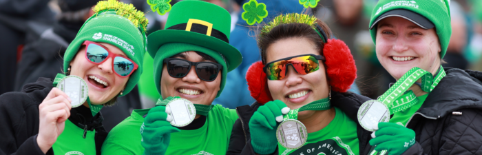 Participants displaying their medals after the 2025 Bank of America Shamrock Shuffle